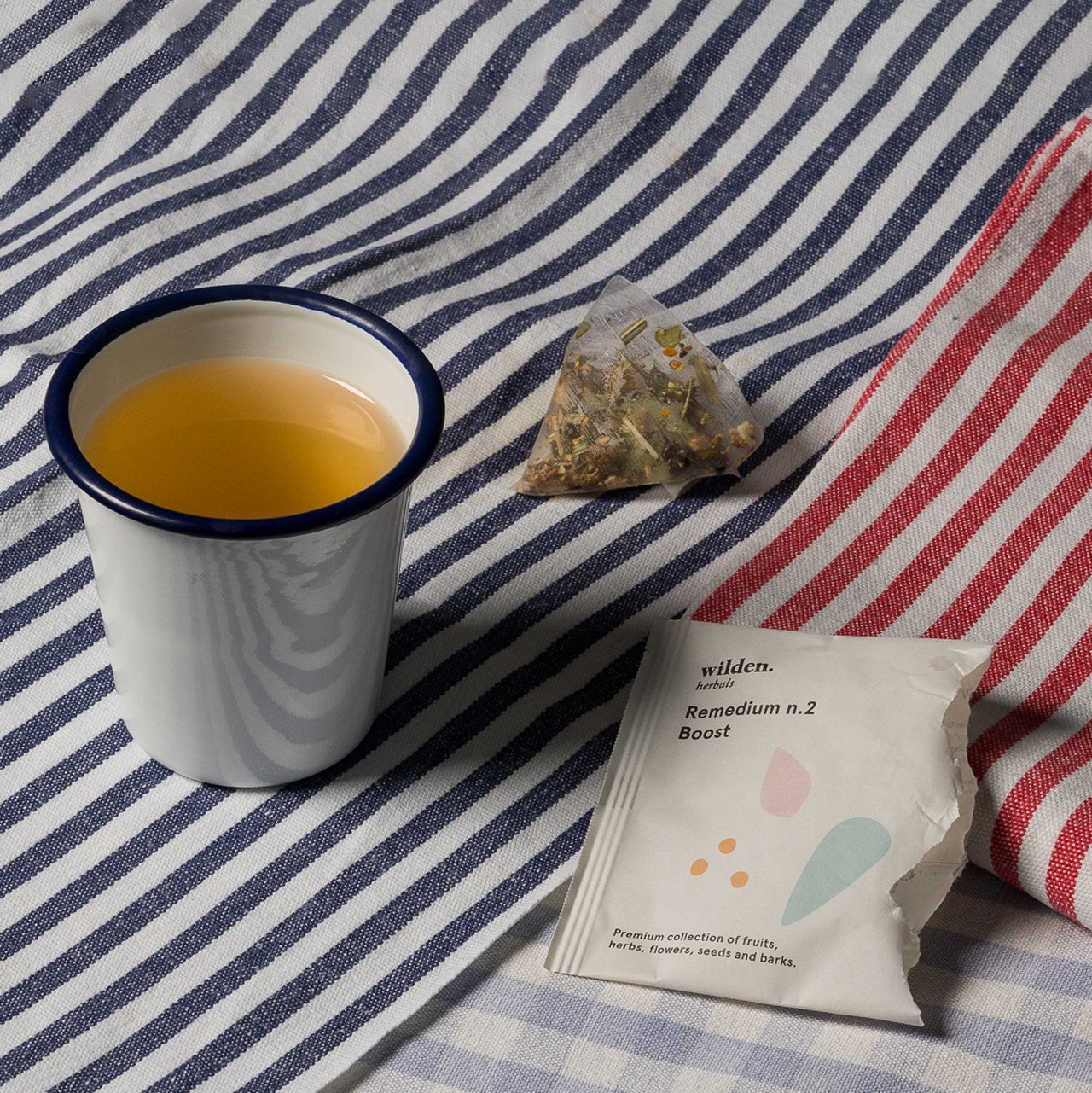 Simple cup of herbal organic infusion with line-pattern fabrics